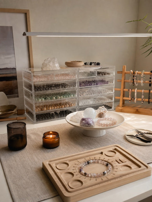 An organized Strandzen workbench with natural bead strands, tools, and a bracelet layout board