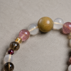 Quiet Keepsake finished crystal bracelet in soft pink, clear, smoky brown, deep red, and warm wood tones thumbnail