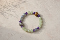 Lotus Start Plan B bracelet photographed on a light textured surface with a botanical shadow thumbnail