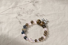 Love Frame Plan B bracelet photographed on natural linen with a soft botanical shadow thumbnail