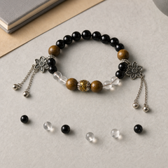 Still Ground Calm crystal bracelet styled on neutral stone with loose beads thumbnail