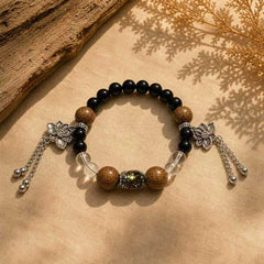 Still Ground Calm bracelet on warm linen with black beads, wood beads, clear quartz, and silver lotus charms thumbnail