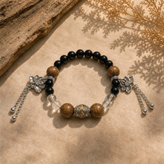 Still Ground Calm bracelet on warm linen with black beads, wood beads, clear quartz, and lotus charms thumbnail