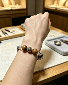 Still Ground Calm bracelet worn on wrist with wood, black, and clear beads thumbnail