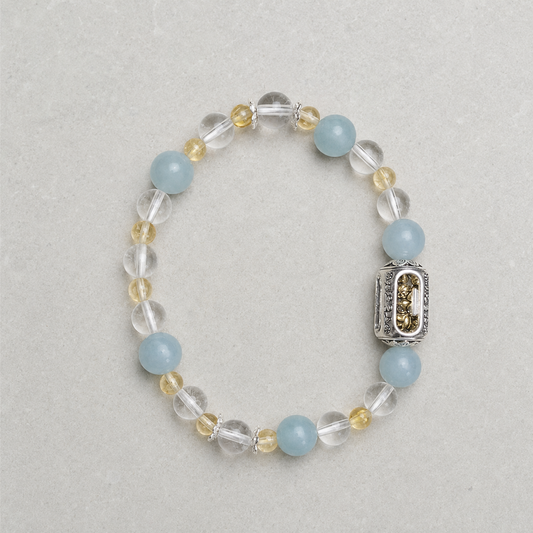 Still Ground Plan B bracelet with pale blue, clear, soft yellow, and silver-tone details on light stone